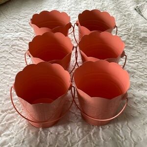 6 decorative metal buckets. Pinky/peach with scalloped tops and handles.